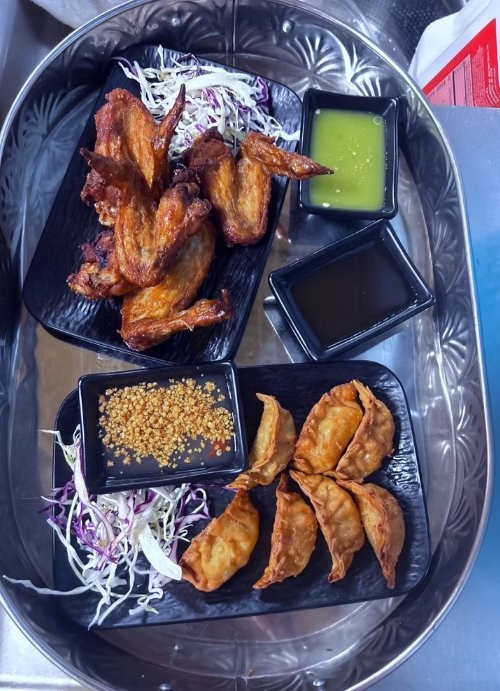 Crispy chicken wings and golden dumplings at Aroy Thai